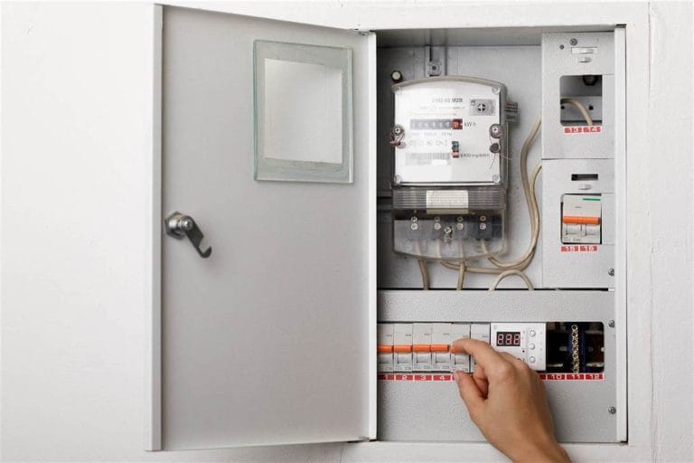 Electrical terminal box. man checking the electric control box. overload relay.